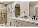 Bright bathroom boasts double vanity, matte black hardware, and shower with rain head and unique wood-look tile at 9545 Eagle Valley Dr, Las Vegas, NV 89134