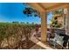 Relaxing outdoor covered patio area with comfortable seating surrounded by lush greenery at 9545 Eagle Valley Dr, Las Vegas, NV 89134