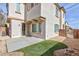 Backyard with a concrete patio and a small patch of artificial turf at 9881 Juno Hills St, Las Vegas, NV 89178