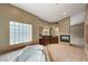 Bathroom showcasing large tub, decorative tilework, double vanities and fireplace at 10626 San Vercelli Ct, Las Vegas, NV 89141