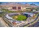 An aerial view of the Las Vegas Ballpark in Summerlin, surrounded by palm trees and commercial buildings with mountains in the background at 10983 Pumpkin Ridge Ave, Las Vegas, NV 89135