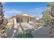 A fully fenced backyard featuring desert landscaping and a covered patio at 10983 Pumpkin Ridge Ave, Las Vegas, NV 89135