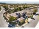 Impressive aerial view of home with a tile roof, desert landscaping, distant city views, and mature trees at 11 Canoa Hills Dr, Henderson, NV 89052