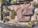 Striking aerial view of home with a tile roof, desert landscaping, backyard pool and spa, and mature palm trees at 11 Canoa Hills Dr, Henderson, NV 89052
