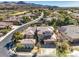 Scenic aerial view of home with a tile roof, desert landscaping, mountain views, and golf course surroundings at 11 Canoa Hills Dr, Henderson, NV 89052