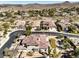 Expansive aerial view of home with mature landscaping, a backyard pool, a tile roof, and a mountain view at 11 Canoa Hills Dr, Henderson, NV 89052