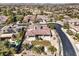 Panoramic aerial view of home with mature landscaping, a backyard pool, tile roof, and golf course surroundings at 11 Canoa Hills Dr, Henderson, NV 89052