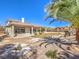 A backyard featuring grass, trees, landscaping, and a covered patio at 11 Canoa Hills Dr, Henderson, NV 89052