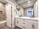 Bright bathroom with double vanity, large mirror, and tiled shower-tub combo at 11 Canoa Hills Dr, Henderson, NV 89052