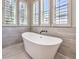 Elegant freestanding bathtub with shuttered windows at 11 Canoa Hills Dr, Henderson, NV 89052