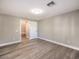 Well-lit room featuring laminate flooring, neutral paint, and an open doorway at 11 Canoa Hills Dr, Henderson, NV 89052