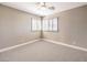 Neutral bedroom showcasing plantation shutters, carpeted floor, and ceiling fan at 11 Canoa Hills Dr, Henderson, NV 89052