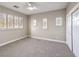 Bright bedroom with neutral walls, carpet, and shuttered windows at 11 Canoa Hills Dr, Henderson, NV 89052