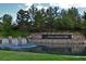 Scenic view of the Anthem Country Club entrance with a waterfall and lush landscaping around the pond at 11 Canoa Hills Dr, Henderson, NV 89052