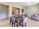 A dining room and living room combo features hardwood floors and a view to the staircase at 11 Canoa Hills Dr, Henderson, NV 89052