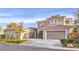 Charming two-story home featuring a tile roof, multiple car garage, stone accents, and a private gated entry at 11 Canoa Hills Dr, Henderson, NV 89052