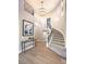 Elegant foyer featuring a grand staircase, chandelier, and hardwood floors at 11 Canoa Hills Dr, Henderson, NV 89052