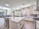 Open-concept kitchen with island, stainless steel appliances, and seamless access to living area at 11 Canoa Hills Dr, Henderson, NV 89052