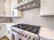 Close-up of a stainless steel stove with a vent hood and white cabinets at 11 Canoa Hills Dr, Henderson, NV 89052
