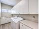 Functional laundry room with sink, countertops, cabinets, and appliances at 11 Canoa Hills Dr, Henderson, NV 89052