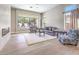 Cozy living room featuring a tiled fireplace and a view of the backyard at 11 Canoa Hills Dr, Henderson, NV 89052