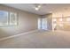 Expansive primary bedroom with neutral tones and view of staircase and windows at 11 Canoa Hills Dr, Henderson, NV 89052