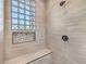 Modern shower with a built-in bench and decorative window at 11 Canoa Hills Dr, Henderson, NV 89052