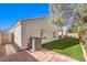 Low-maintenance backyard showcasing artificial turf, brick patio, and the home's exterior at 1590 Raining Hills St, Henderson, NV 89052