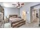Cozy bedroom features a ceiling fan, a rustic wood bed frame and a large dresser at 1590 Raining Hills St, Henderson, NV 89052