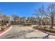 Community entrance with manicured landscaping and gated access for enhanced security at 1590 Raining Hills St, Henderson, NV 89052