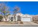 Charming single-story home with a two-car garage and well-maintained desert landscaping at 1590 Raining Hills St, Henderson, NV 89052