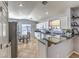 Bright and airy kitchen with stainless steel appliances, a dining area, and ample counter space at 1590 Raining Hills St, Henderson, NV 89052
