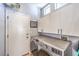 Laundry room features modern appliances and cabinets to organize your cleaning supplies at 1590 Raining Hills St, Henderson, NV 89052