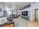 A spacious living room with a large sectional sofa, neutral carpet, and large windows at 1590 Raining Hills St, Henderson, NV 89052