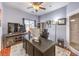 This office provides a practical work area with a large desk, ceiling fan and natural light at 1590 Raining Hills St, Henderson, NV 89052