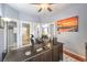 Bright home office with natural light and access to the bathroom features a large desk at 1590 Raining Hills St, Henderson, NV 89052