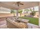 Cozy covered patio featuring comfortable seating and a view of the well-maintained backyard at 1590 Raining Hills St, Henderson, NV 89052