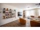 Cozy living room featuring floating shelves, a large TV, and modern, neutral-toned furniture at 1653 Sun Canyon Ct, Las Vegas, NV 89128