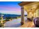Covered back patio with a ceiling fan, outdoor dining set, and desert views at 2062 Dipinto Ave, Henderson, NV 89052