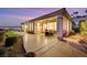 Covered patio with patio furniture, outdoor kitchen, and desert landscape views at 2062 Dipinto Ave, Henderson, NV 89052