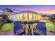 Outdoor seating area on a backyard patio overlooking lush greenery, offering a tranquil and relaxing retreat at 2062 Dipinto Ave, Henderson, NV 89052