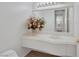 Bright bathroom featuring an undermount sink with white countertops and a large mirror and overhead vanity lighting at 2062 Dipinto Ave, Henderson, NV 89052