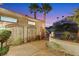 Private courtyard entrance with decorative iron gates and lush landscaping at dusk at 2062 Dipinto Ave, Henderson, NV 89052