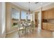 Cozy dining area boasts natural light and scenic views, complemented by wood cabinets in the nearby kitchen at 2062 Dipinto Ave, Henderson, NV 89052