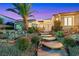 Inviting front entrance with stone walkway, mature landscaping, and a glimpse of the home's architectural details at 2062 Dipinto Ave, Henderson, NV 89052