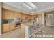 Well-lit kitchen featuring stainless steel appliances, wood cabinetry, and a granite-topped island with bar stool seating at 2062 Dipinto Ave, Henderson, NV 89052