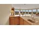 An open kitchen with granite countertops, ample cabinetry, and views to the outside at 2062 Dipinto Ave, Henderson, NV 89052
