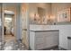 Stylish bathroom with a gray vanity, tiled backsplash, and walk-in closet access at 30 Via Tiberius Way, Henderson, NV 89011