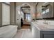 Well-lit bathroom featuring soaking tub and double vanity, flowing to bedroom at 30 Via Tiberius Way, Henderson, NV 89011