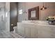 Elegant bathroom featuring a marble countertop, custom cabinetry, and a frameless glass shower at 30 Via Tiberius Way, Henderson, NV 89011